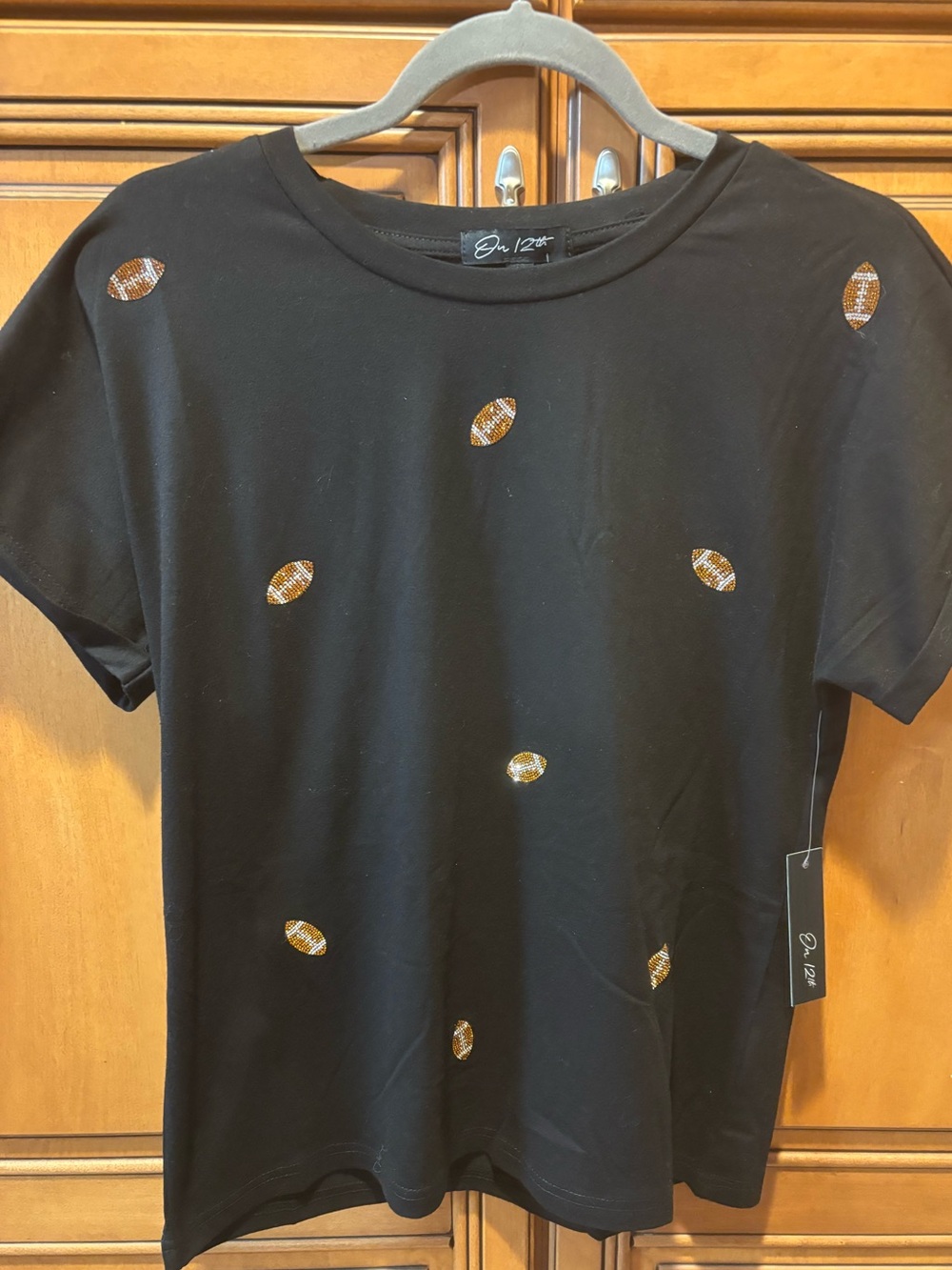 *NWT* Rhinestone football T-shirt. Size: M